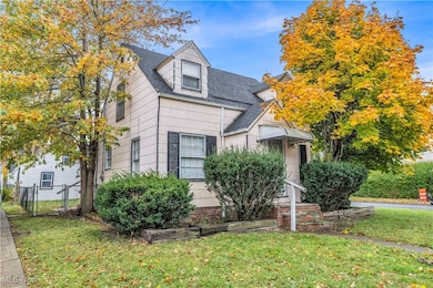 View of front of property with roof with shingles and a gate
