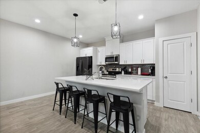 Kitchen featuring backsplash, appliances with stai