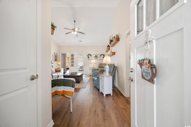 Living area with ceiling fan, wood finished floors