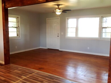 View from Kitchen and Dining.  The Living Room has original Hardwood Flooring and several Windows to allow the Natural Light in.
