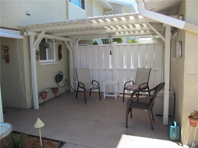 This covered patio sites behind the garage. Enjoy 