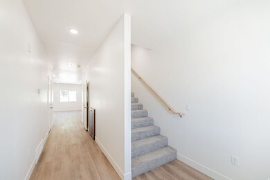 Stairway with wood finished floors and recessed lighting