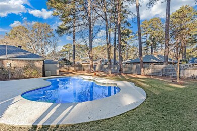 View of pool with a storage shed, a lawn, and a pa