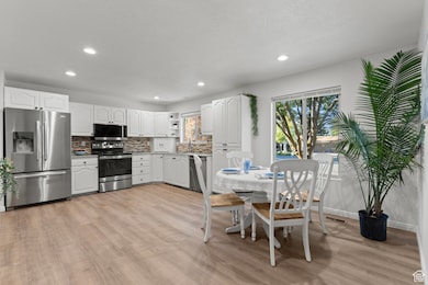 Dining space featuring light wood finished floors and recessed lighting