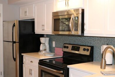 Kitchen view with glass backsplash