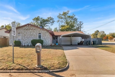 Single story home with stone siding and driveway