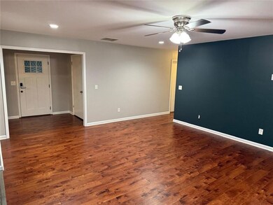 Empty room with ceiling fan, dark wood-style floors, and recessed lighting