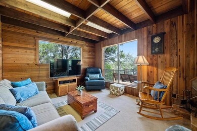 Carpeted living area featuring wood walls and a w