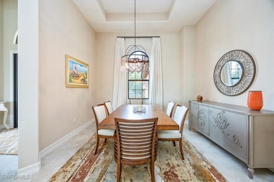 Dining room featuring baseboards, a chandelier, an