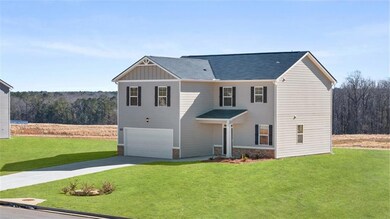 View of front facade featuring driveway, a garage,