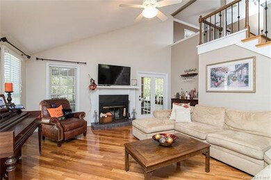 Two story living room with fireplace and bar