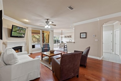 Living room with ceiling fan, arched walkways, wo