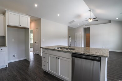 Kitchen featuring sink, white cabinets, vaulted ce