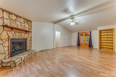 Living Room featuring Stone Fireplace with gas logs