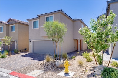 View of front facade with stucco siding, a garage,