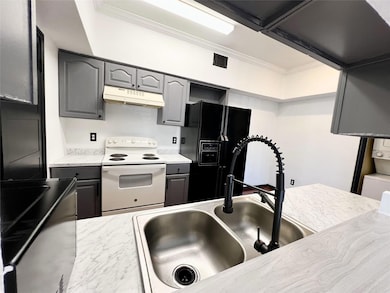 Kitchen featuring black refrigerator with ice disp