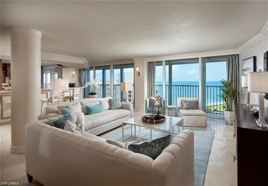 Tiled living room with a water view and crown molding