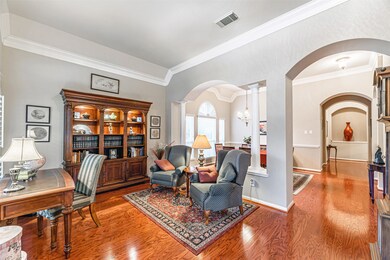 This room is separated from the dining room with large arched walkways and columns.