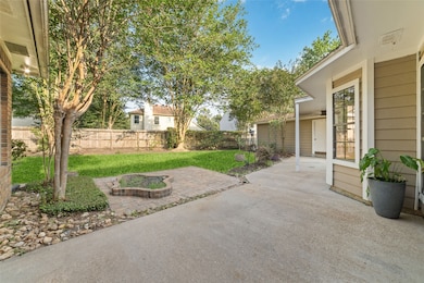 This backyard features a spacious patio with a pav