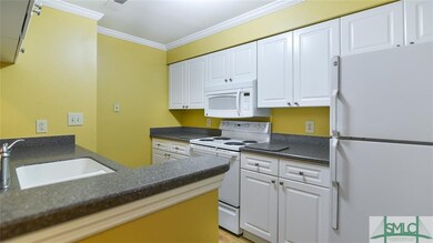 Kitchen with Corian counters and white appliances