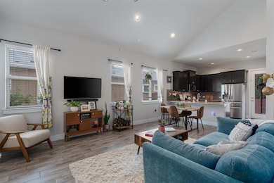 Living room with vaulted ceiling, light wood-type