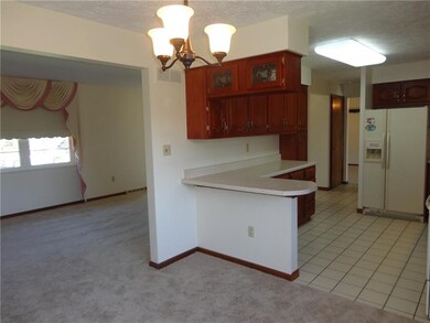 DINING ROOM VIEW OF LIVING ROOM AND KITCHEN.