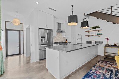 Kitchen featuring stainless steel fridge, a sink,