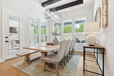 Dining area with beamed ceiling, wood-type floorin