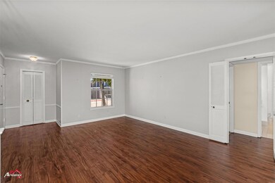 Spare room with crown molding and dark hardwood / 