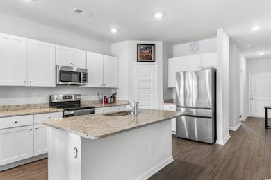 Kitchen with appliances with stainless steel finis