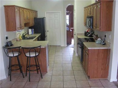 Kitchen boasts tile flooring, Kenmore drop in rang