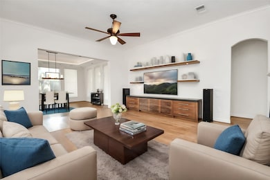 This view of the living room and
dining area highlights the open
and airy layout of the home. The
hardwood floors and neutral walls
provide a versatile backdrop for
any décor style. The modern light
fixtures and large windows
enhance the space’s contemporary
feel, making it ideal for gatherings
and everyday living.