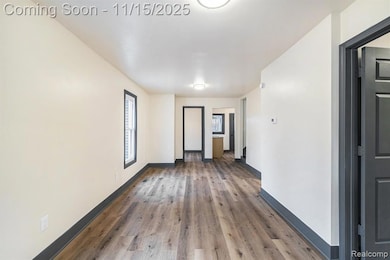 Spare room featuring wood finished floors and baseboards