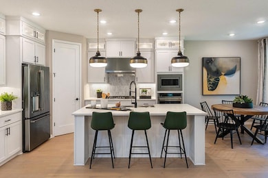 Kitchen with light countertops, a kitchen breakfa