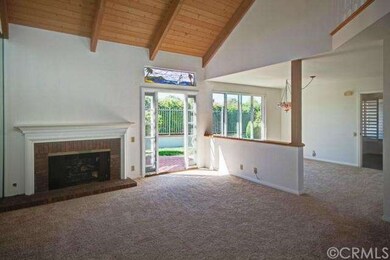 Living room with vaulted ceiling and fireplace adj