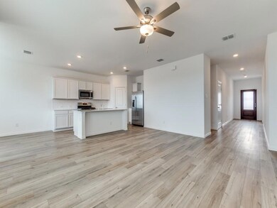 Open concept floorplan. Lovely breakfast bar. Door near the island is a huge walk-in pantry. Al new appliances.