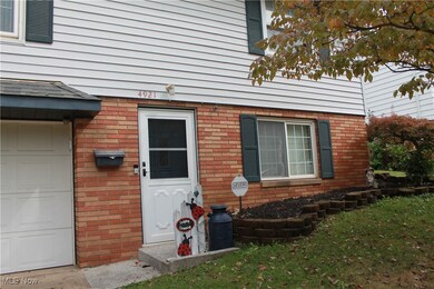 Doorway to property with a garage