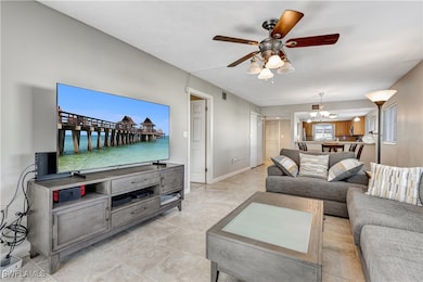 Living room with ceiling fan and a chandelier