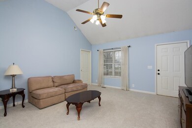 Living room has vaulted ceilings welcoming guests into a spacious feeling home.
