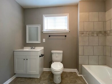 Bathroom with toilet, baseboards, and vanity