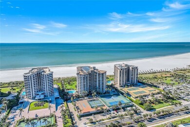 Drone / aerial view with a water view and a beach