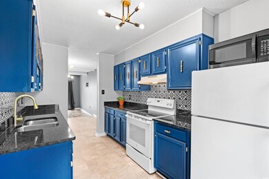 Kitchen featuring tasteful backsplash, blue cabine