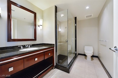 Bathroom with visible vents, toilet, a stall showe