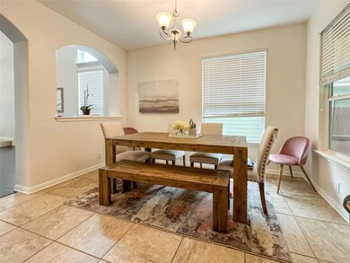 Dining room with light tile patterned floors, a c