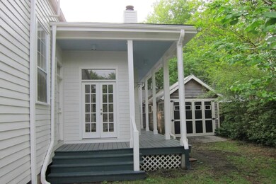 SIDE PORCH DOORS TO DEN AND GARAGE ON THE RIGHT