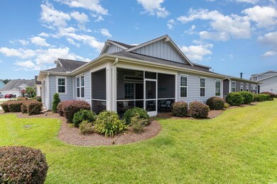 Back of property featuring a sunroom and a yard