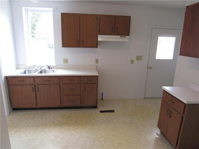 Eat in kitchen with neutral flooring and white wal