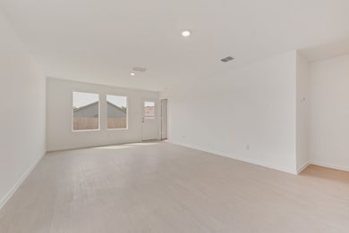 Spare room featuring light wood finished floors and recessed lighting