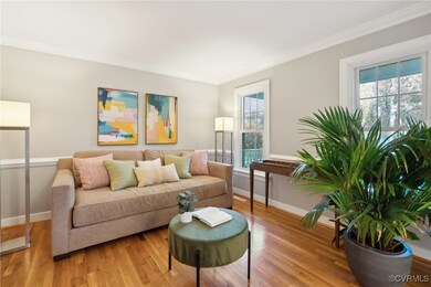 Living room featuring light hardwood / wood-style floors and ornamental molding