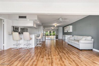 Unfurnished living room with ceiling fan and light